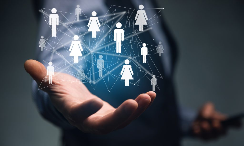 Mão aberta com ícones conectados representando pessoas em rede digital, simbolizando estratégias para construir audiência com GPT.