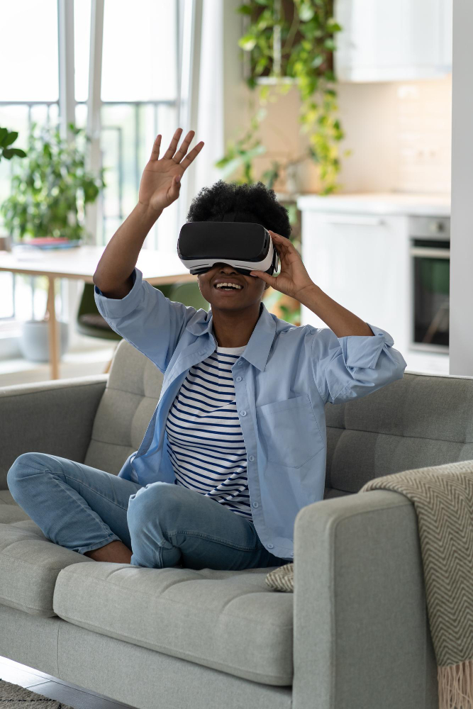 happy-excited-young-black-woman-enjoying-virtual-reality-shopping-experience-while-resting-home-1